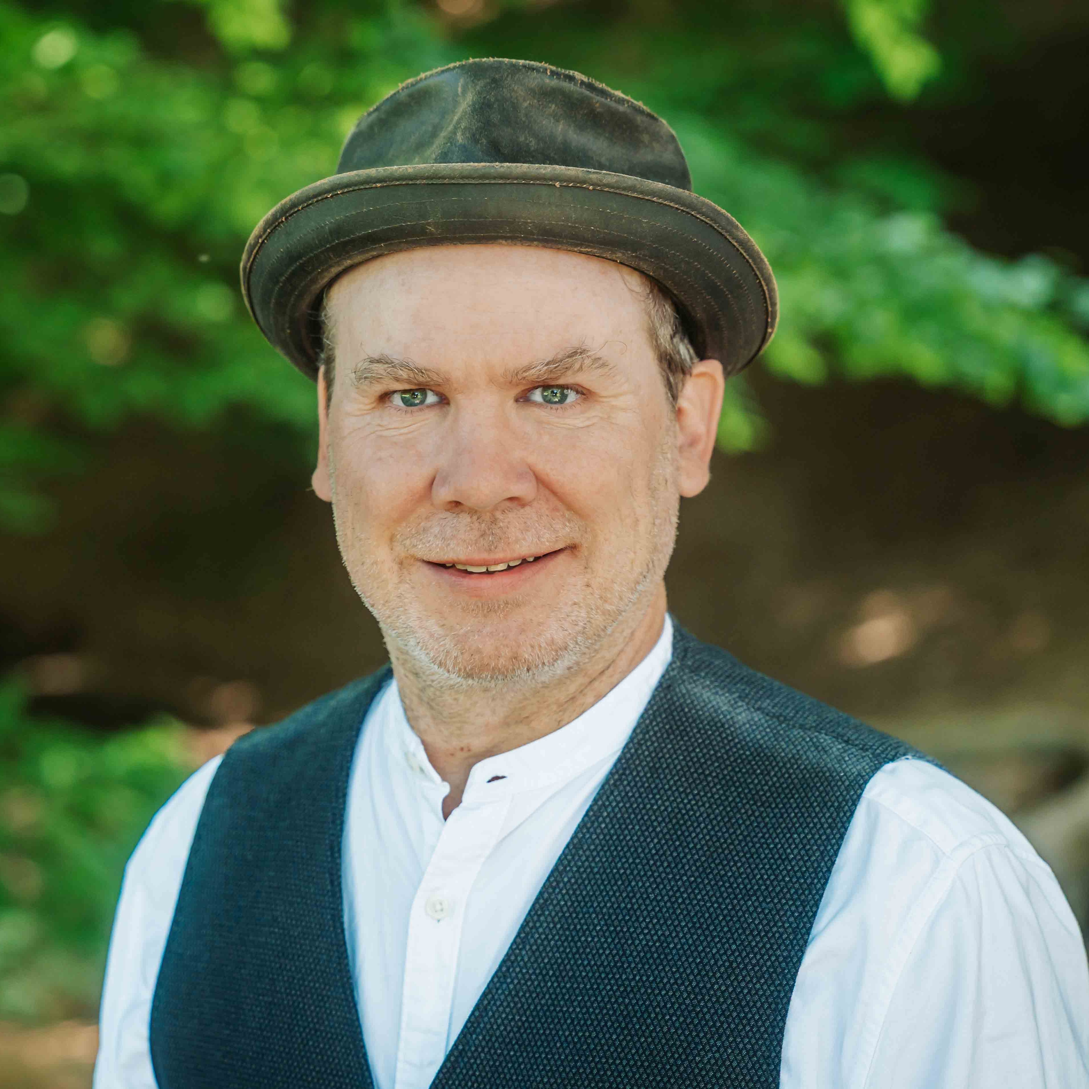 Alea Portrait eines Mannes mit Hut und Weste im Grünen