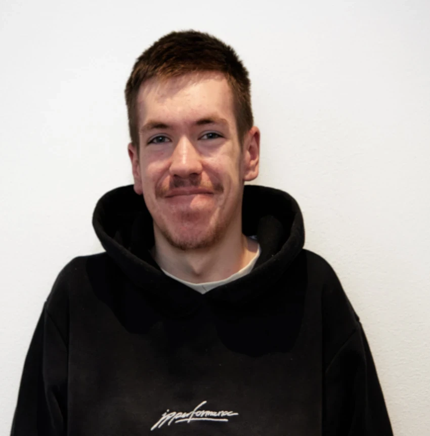 Jakob Schleppner in schwarzem Hoodie vor weißer Wand