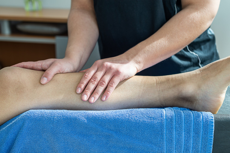 Lymphdrainage am Bein – professionelle manuelle Lymphdrainage Behandlung Lymphdrainage am Bein – Therapeut führt manuelle Lymphdrainage durch