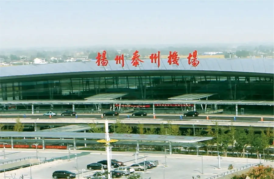 Außenansicht des Flughafens Yangzhou in China mit dem Terminalgebäude und Parkplätzen