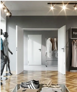 Stahl-Objektüren in einem modernen Geschäft mit Kleidungsstücken und Schaufensterpuppen