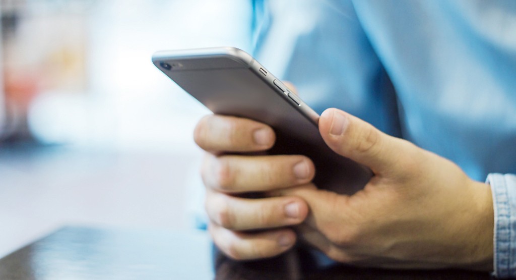 Prostata Hilfe Deutschland: Illustrationsbild - Mann hält Handy in der Hand.