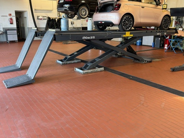 Auto auf Hebebühne in einer Werkstatt, moderne Fahrzeugwartung