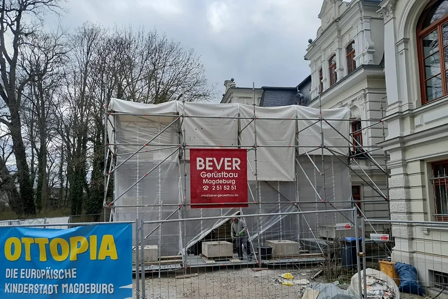 Wetterschutz von BEVER Gerüstbau Magdeburg an einer Baustelle mit historischem Gebäude Wetterschutz am Gerüst von BEVER Gerüstbau Magdeburg an einer Baustelle vor einem historischen Gebäude