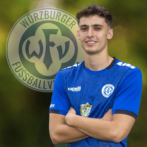 Fußballspieler in blauem Trikot des Würzburger Vereins mit Vereinslogo im Hintergrund