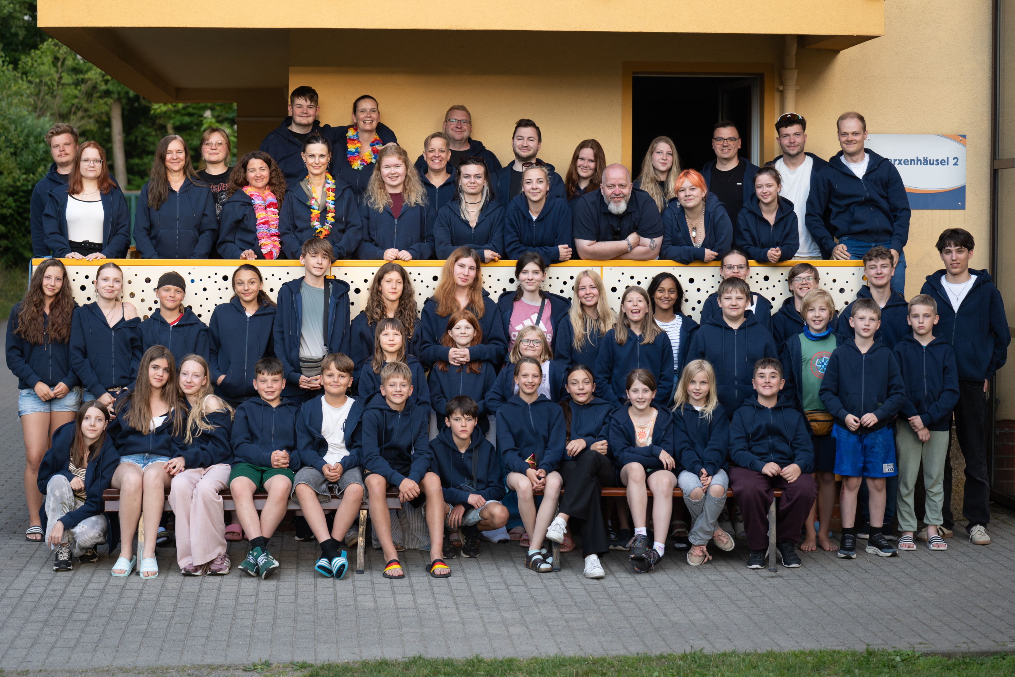 Gruppenfoto beim Ferienlager in Seifhennersdorf, Jugendliche und Betreuer gemeinsam vor dem Gebäude
