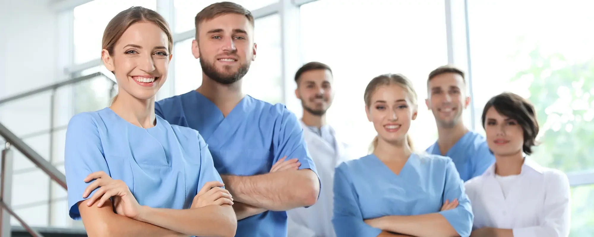 Auszubildende im medizinischen Bereich in blauer Berufskleidung als Headerbild