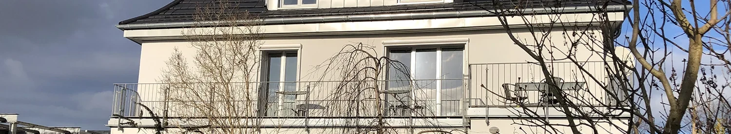 Moderner Bürogebäudekopf mit Balkon und Fensterfront
