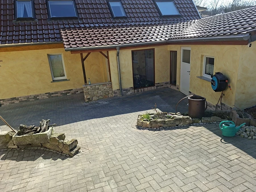 Referenzprojekt von CW Partnerputz: Sanierte Hausfassade mit Hof und Pflasterarbeiten