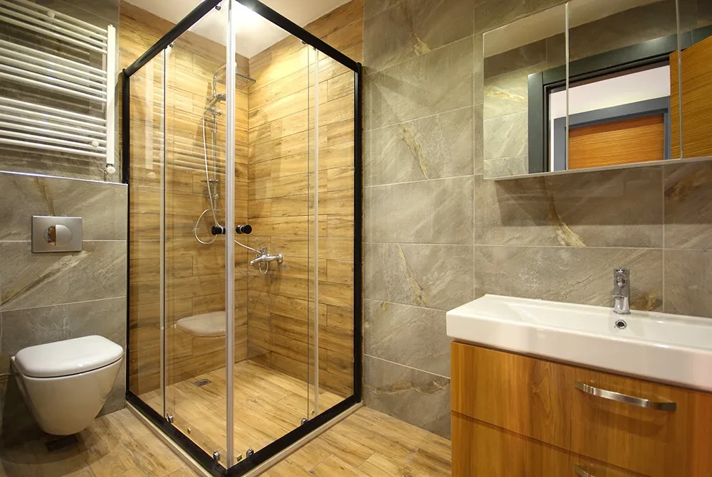Modernes Badezimmer mit Holzoptik-Fliesen und Glasdusche