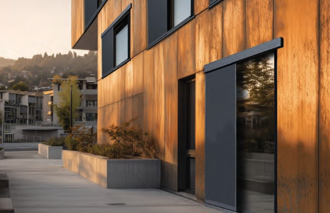 Moderne Fassade mit PV-Schiebeladen in Freiburg bei Sonnenuntergang