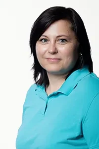 Carola Marquardt im Porträt mit türkisfarbenem Hemd Carola Marquardt in einem türkisfarbenen Hemd vor weißem Hintergrund