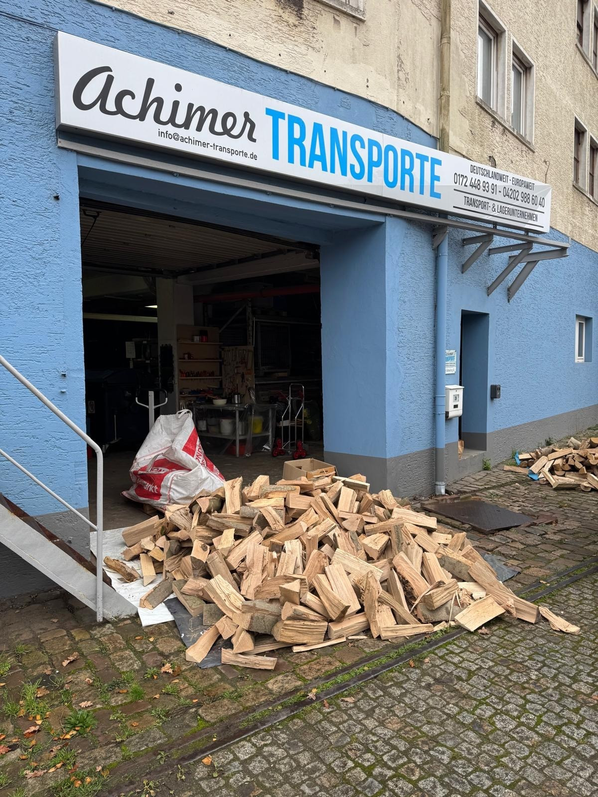 Gestapeltes Brennholz vor dem Lager von Achimer Transporte