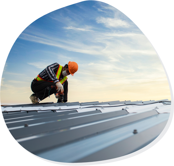 Startseite Contentbild: Handwerker arbeitet auf einem Metalldach bei Sonnenuntergang, abstraktes Motiv