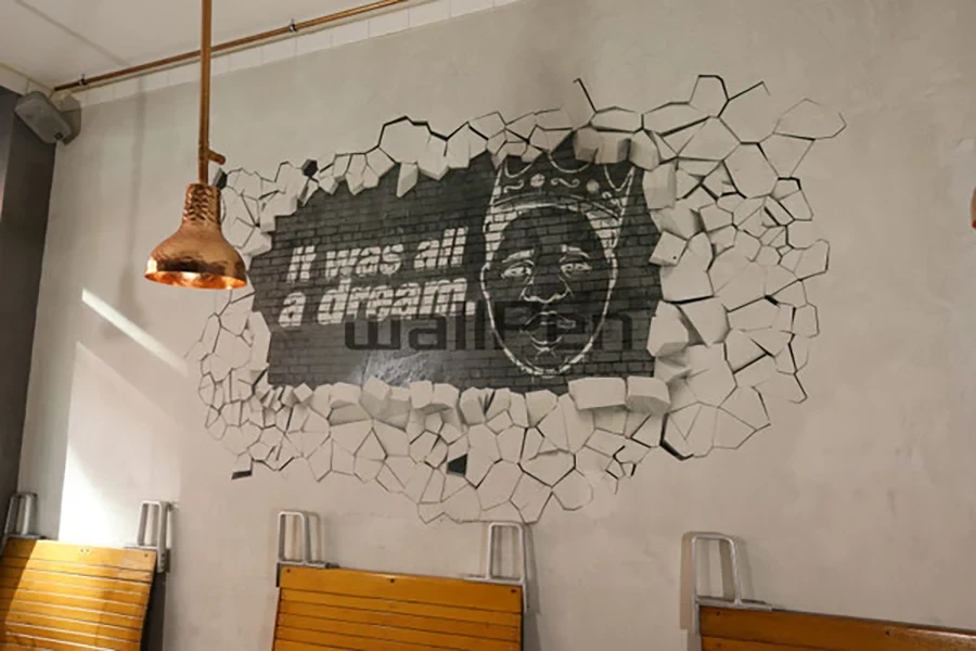 Wanddrucker Motiv mit 3D-Effekt und Graffiti 'It was all a dream' auf einer Backsteinwand