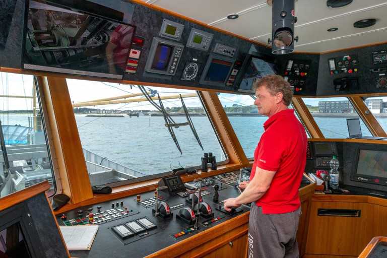 Kapitän Olaf Kleye steuert das Fischereischiff mit Blick auf das Wattenmeer.