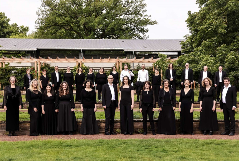Gruppenbild beim Mantelhaus Kaiser im Freien Gruppenfoto vor dem Mantelhaus Kaiser, mehrere Personen in schwarzer Kleidung im Freien