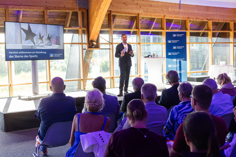 Sterne des Sports 2023 Verleihung bei der Hannoverschen Volksbank mit Redner auf der Bhne Verleihung der Sterne des Sports 2023 bei der Hannoverschen Volksbank, Redner auf der Bhne vor Publikum