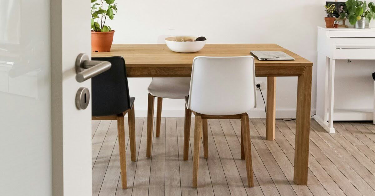 Selbstgebauter Holztisch mit Stühlen und Pflanze Holztisch mit Stühlen und Pflanze auf Holzboden