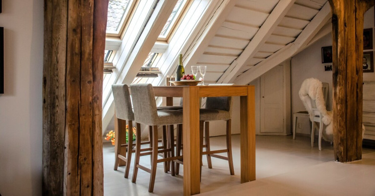 Esstisch aus Holz im modernen Dachgeschoss – stilvolle Einrichtungsidee Moderner Esstisch aus Holz mit vier Stühlen in einem hellen Dachgeschosszimmer