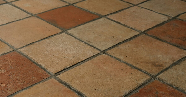 Natursteinfliesen als Küchenboden in warmen Erdtönen