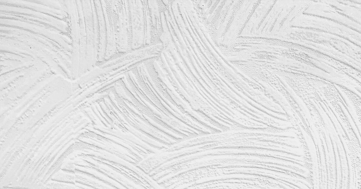 Strukturierter weißer Putz an einer Wand – Detailaufnahme