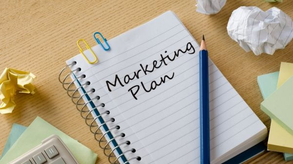 Marketing Plan Notizbuch mit Bleistift Notizbuch mit der Aufschrift 'Marketing Plan' und einem Bleistift