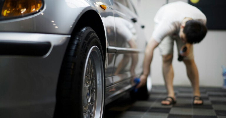 Auto pflegen: Nahaufnahme eines Mannes beim Reinigen eines Autos