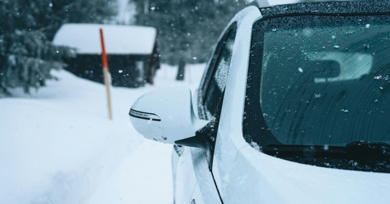 Weißes Auto im Winter mit Schnee bedeckt