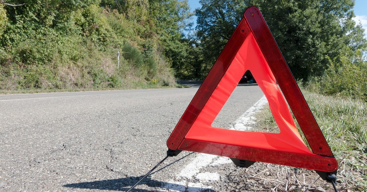 Warndreieck auf Landstraße als Warnsignal bei Panne oder Unfall