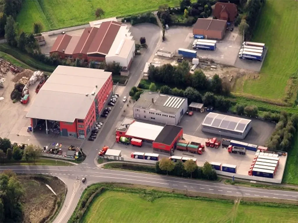 Luftaufnahme unserer Standorte mit Lagerhallen, Bürogebäuden und LKWs