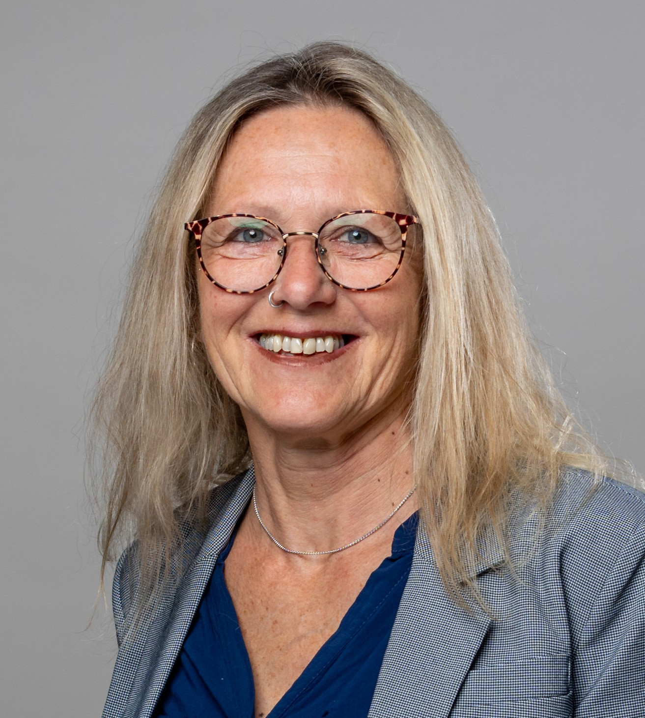 Portrait von Karoline Lohner, Senior Sales Manager Portrait von Karoline Lohner, Senior Sales ManagerKaro Lohner im Business-Outfit vor grauem Hintergrund