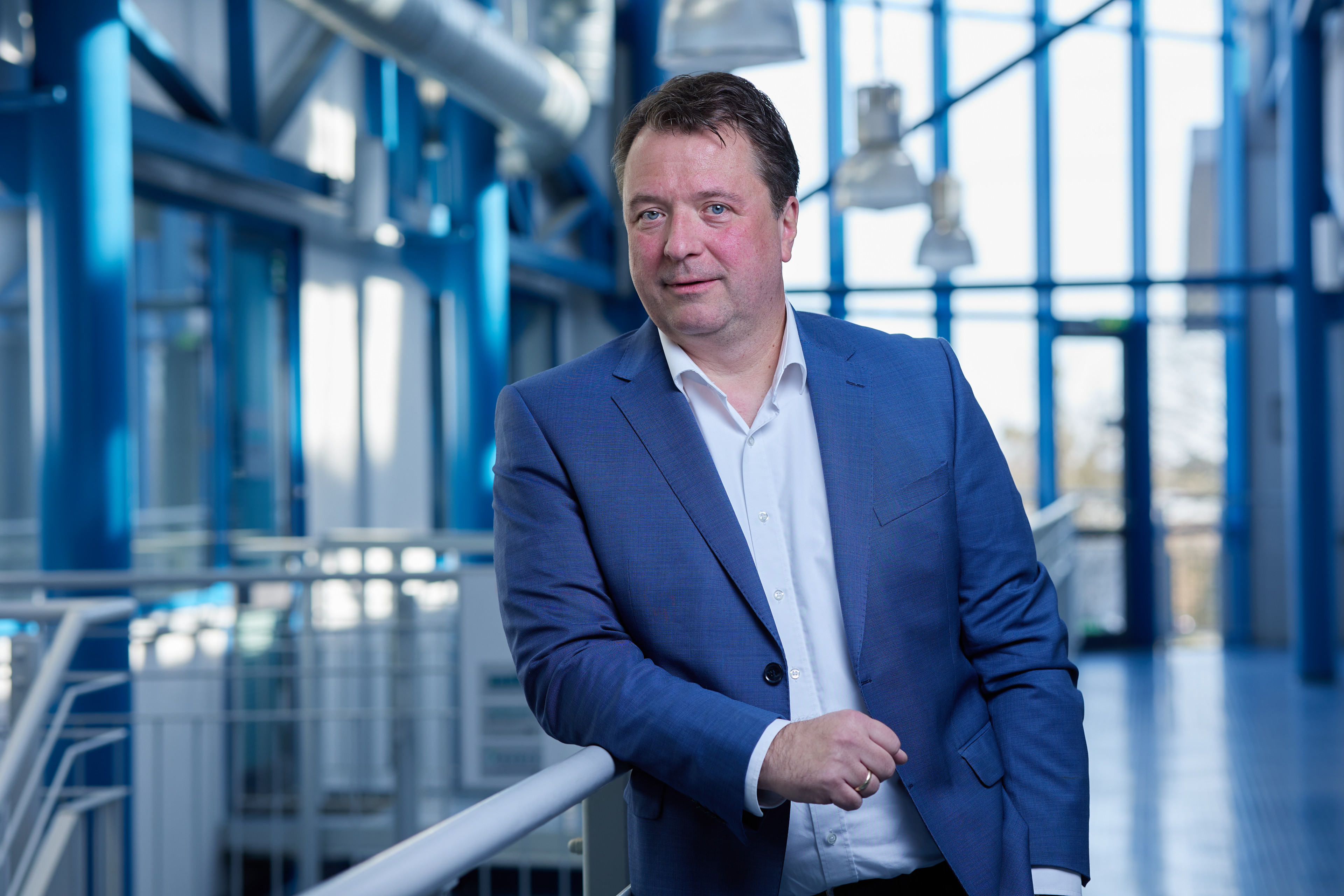 Geschäftsmann im blauen Anzug in moderner Umgebung, Schlutersche Magdeburg